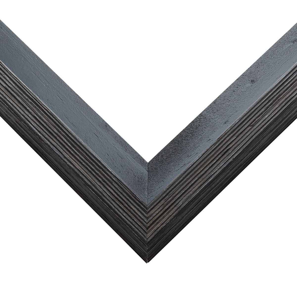 Weathered charcoal gray barnwood canvas float frame corner with a textured wood grain, framing a stretched canvas with a reveal gap