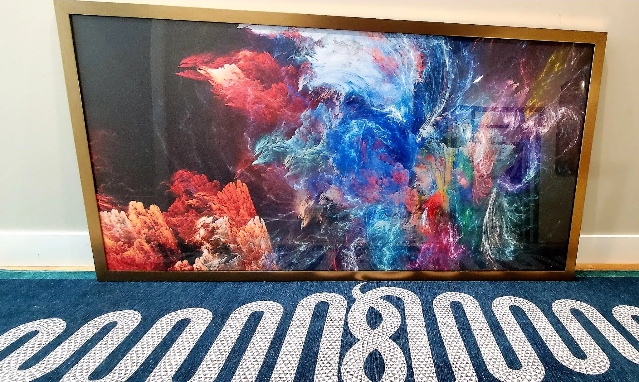 A customer photo of a large fractal print in a gold frame