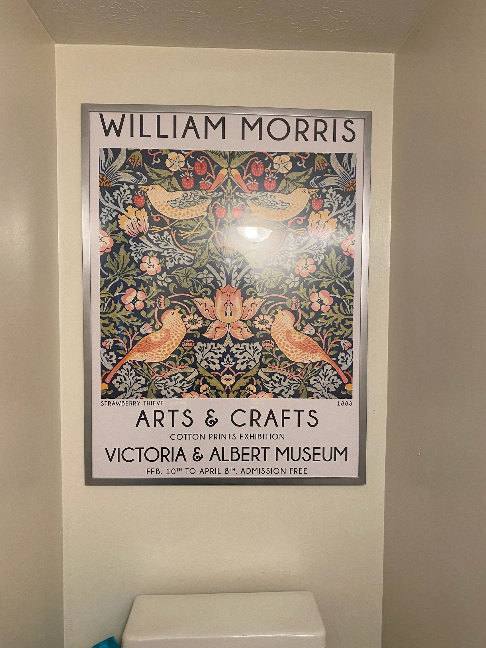 A customer photo of a framed William Morris exhibition print hung on the wall